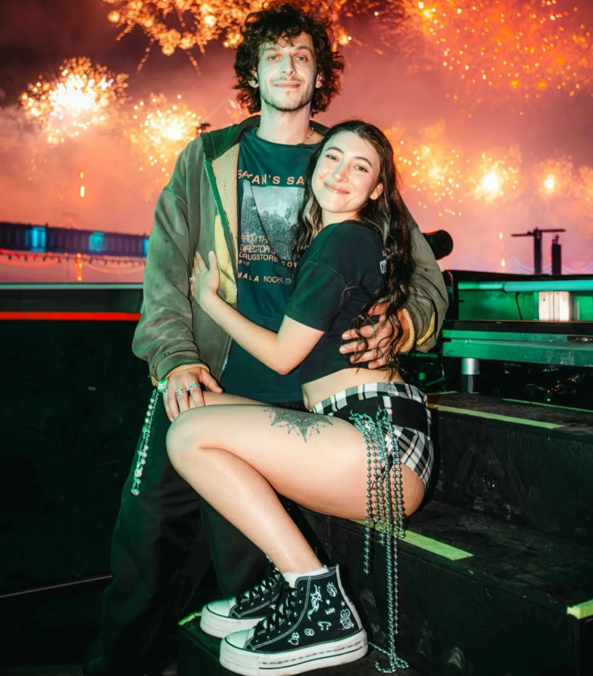 Leveltronics on stage embracing as fireworks explode behind them